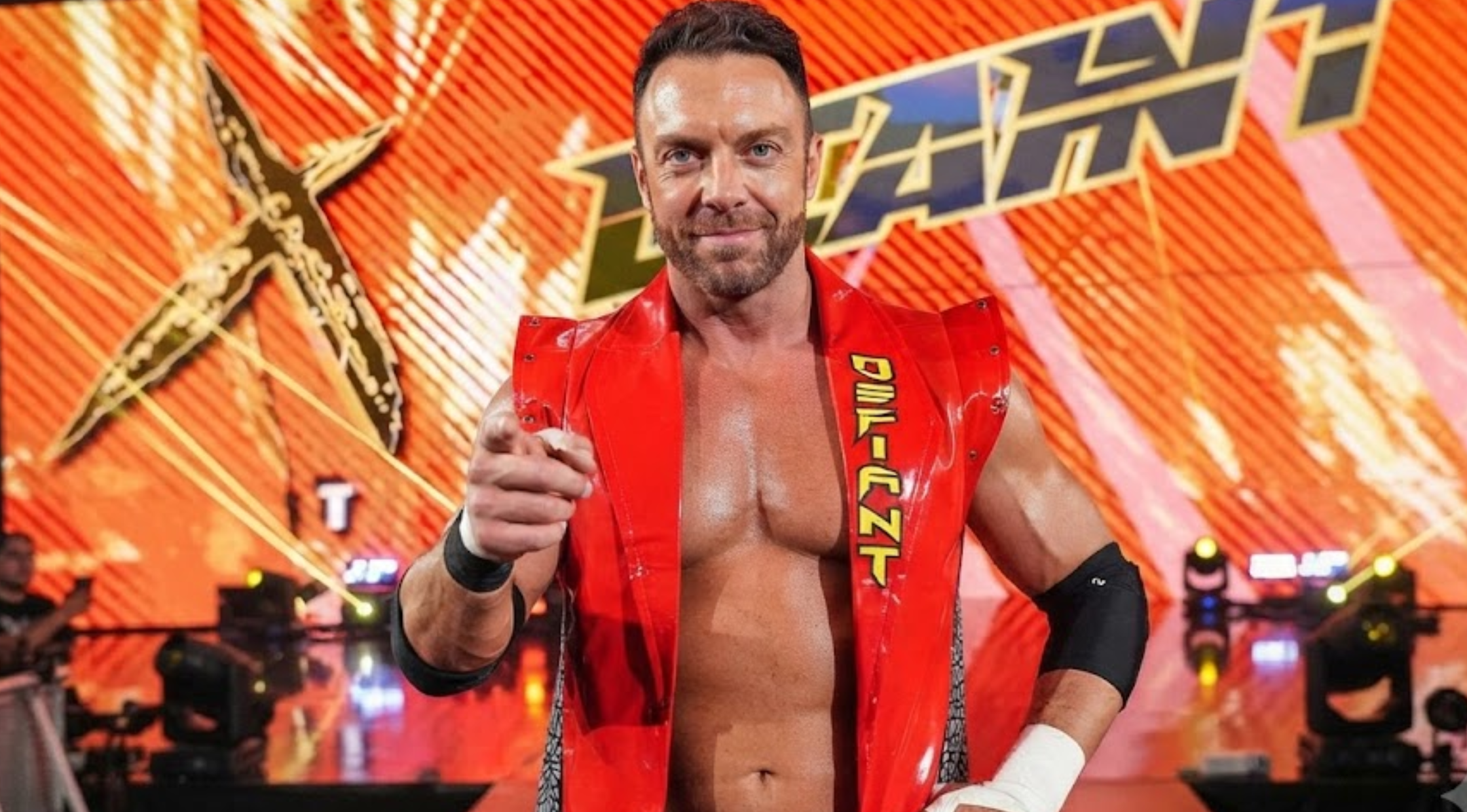 LA Knight Monday Night RAW 2026 Red Patent Leather Biker Vest with Studded Shoulders and DEFIANT Print
